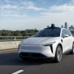 Automated vehicle traveling on an American highway during daylight, with no visible text, license plates or logos
